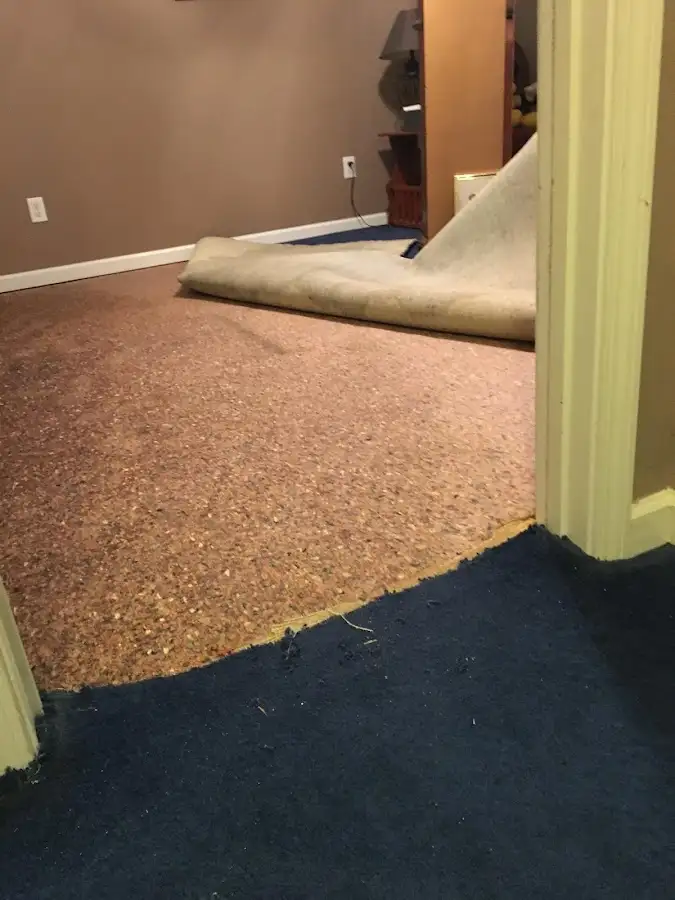 Carpet pad removal revealing water damage during Drying & Dehumidification in Kosciusko